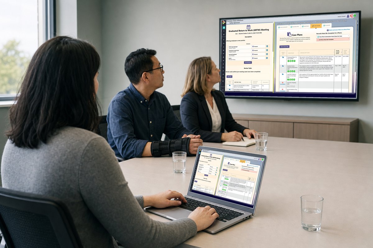 A case manager reviewing a return-to-work plan on her laptop with a returning employee and a supervisor across the table, the same plan on the meeting-room display.